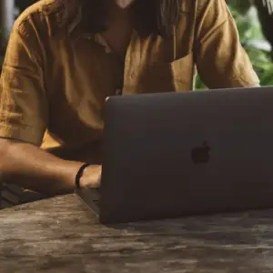 A therapist on a laptop attending a session.